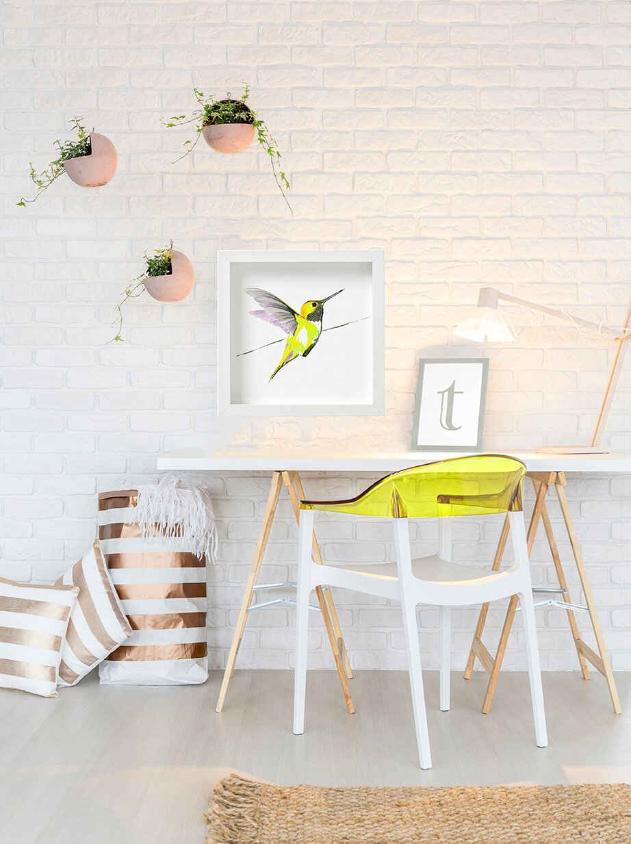 Hummer in yellow framed print 50cm x 50cm hung above a white desk with a yellow chair - by artist Anna Jacobs