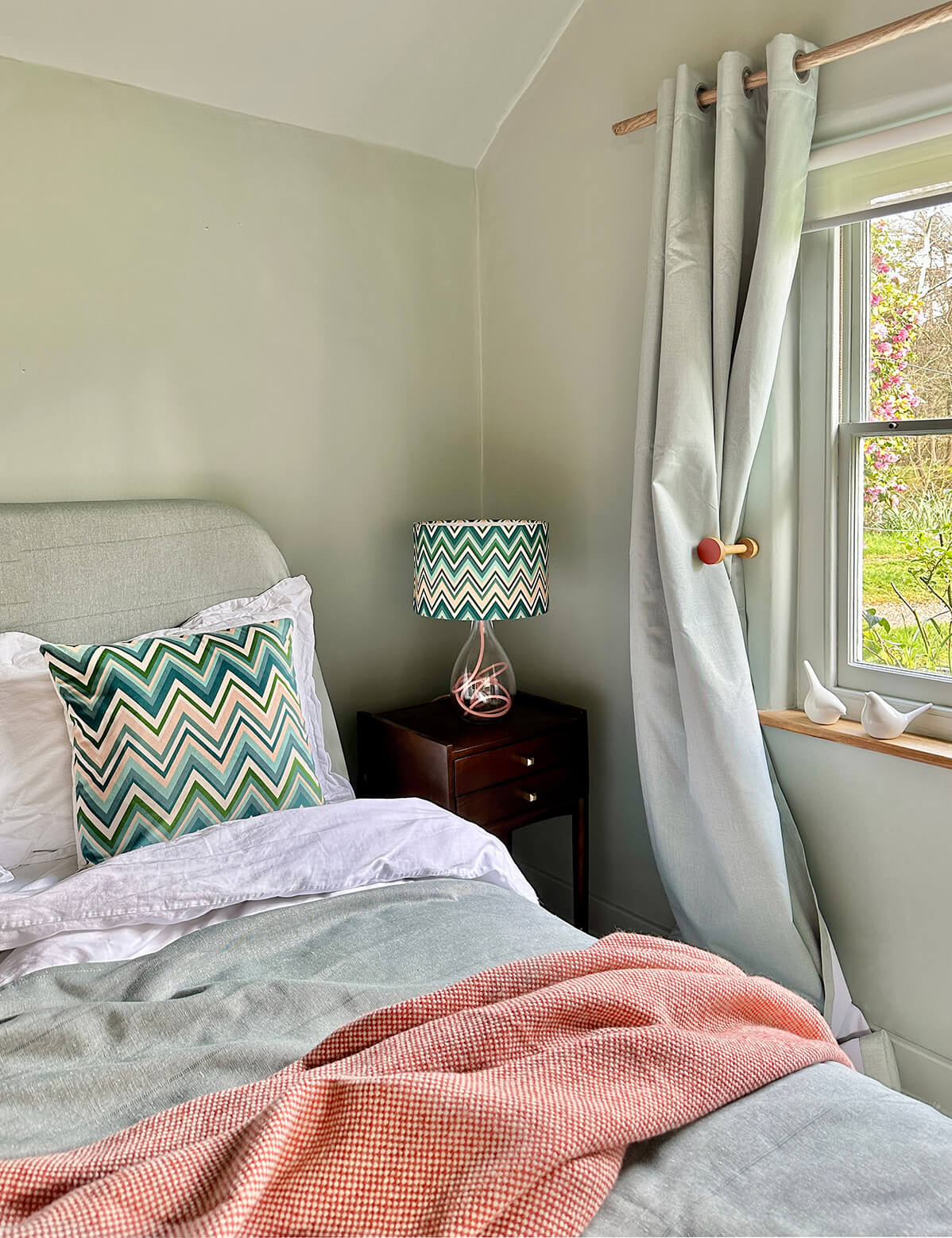 Blue, green and plaster pink zig zag velvet cushion by artist Anna Jacobs - cut out on white background