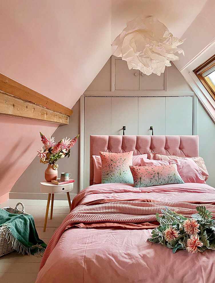 Flight at Dusk cushion in Salmon fading to Jade with seed heads flying across it.