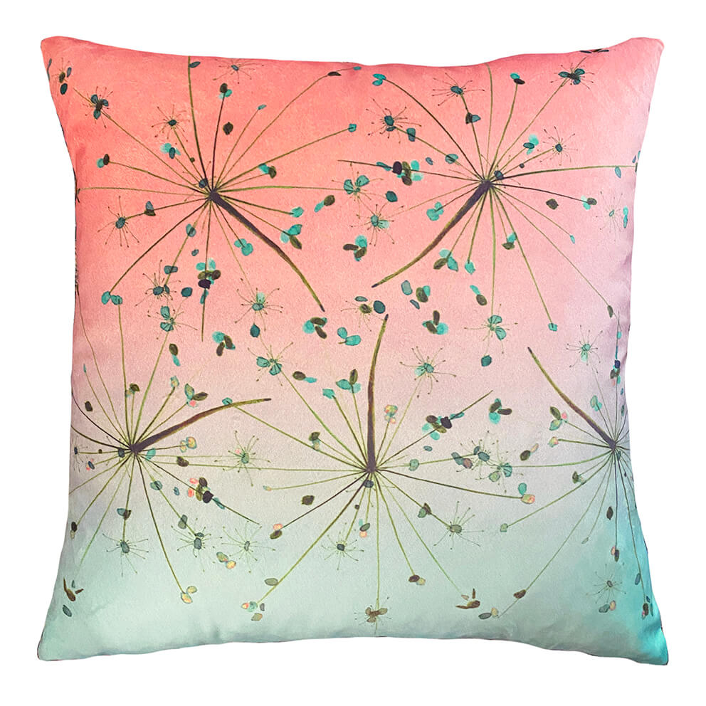 Flight at Dusk cushion in Salmon fading to Jade with seed heads flying across it.