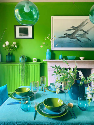 Framed large Breathe print hanging in the broght green and blue kitchen of artist Anna Jacobs