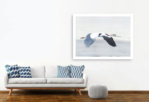 Heron print - Streamline by Anna Jacobs -  hanging on white wall beside grey sofa
