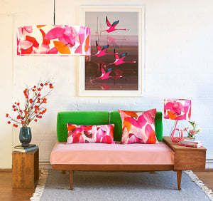 Anna Jacobs Falling leaves in Autumn linen bolster lifestyle image on sofa with lamp and shade